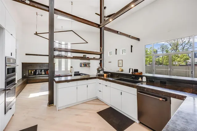 a bathroom with a double vanity sink and mirror with bathtub
