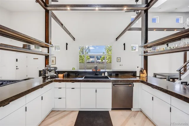 a kitchen with granite countertop a sink and cabinets