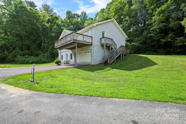 a view of a house with a yard and trees