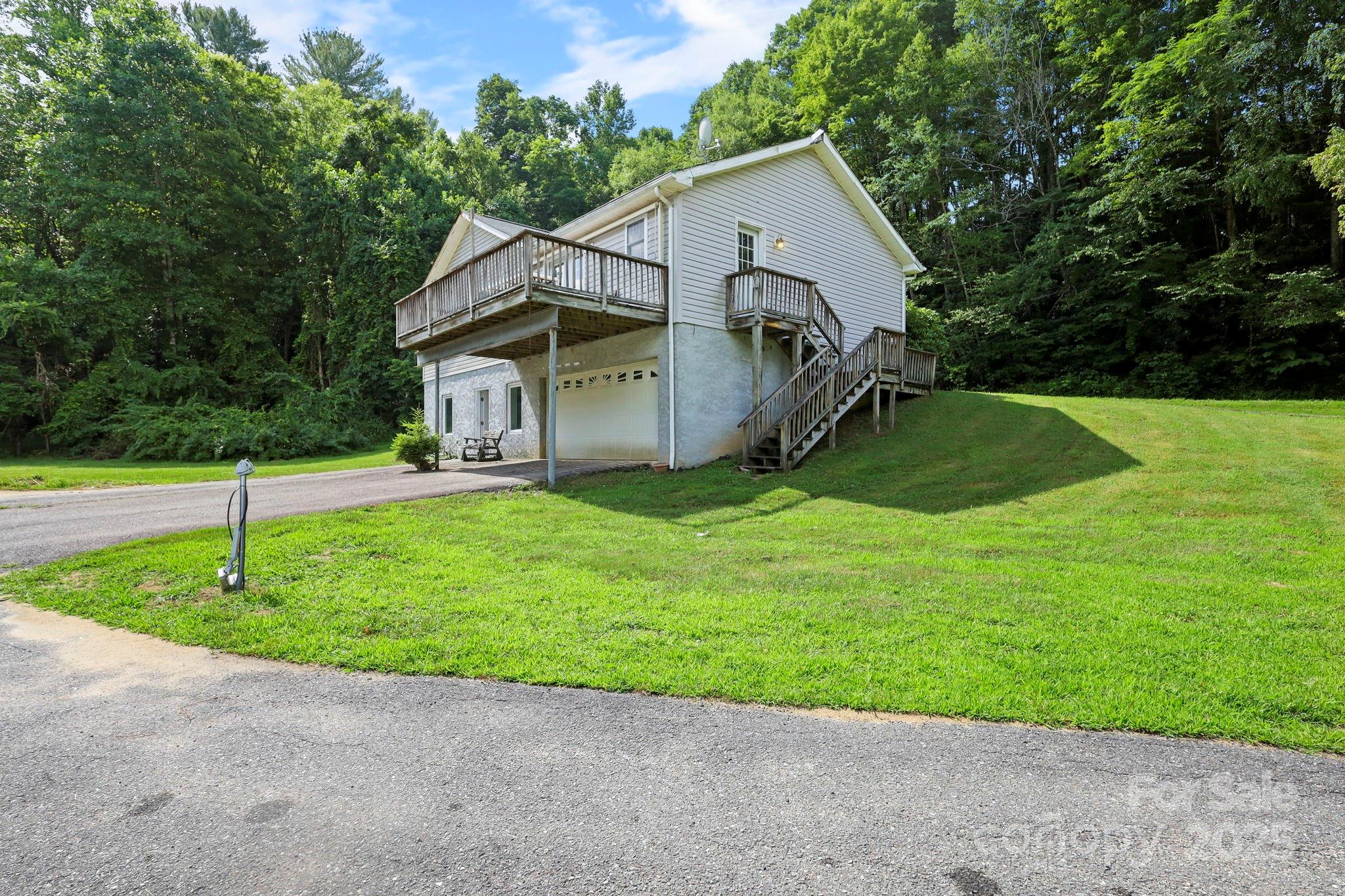a view of a house with a yard and trees