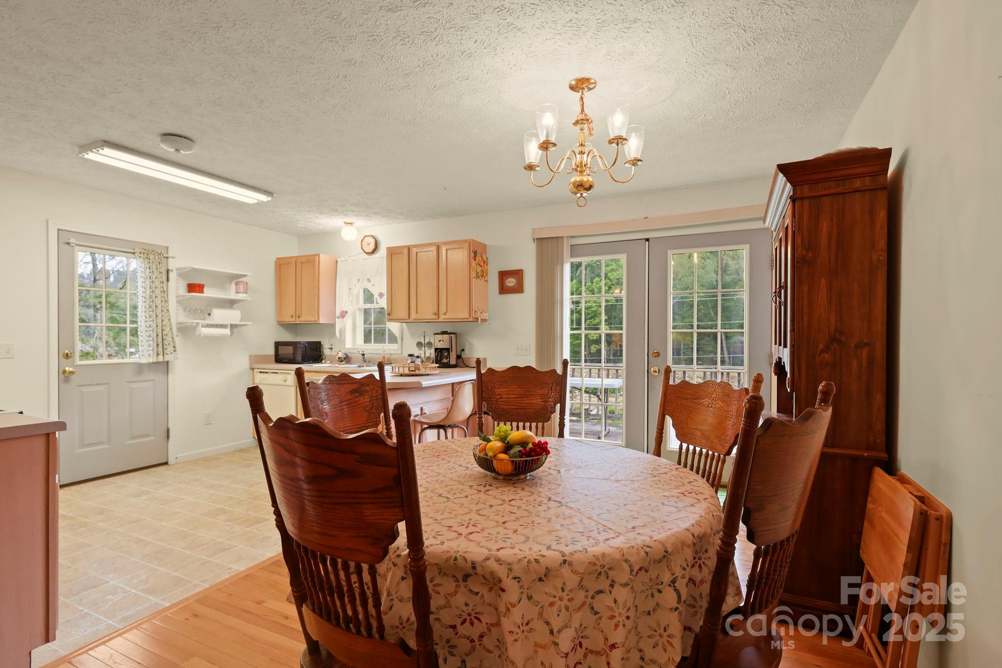 31 Barlow Road Elk Park, NC 28622 - Photo 12 of 40 a dining room with furniture a chandelier and window