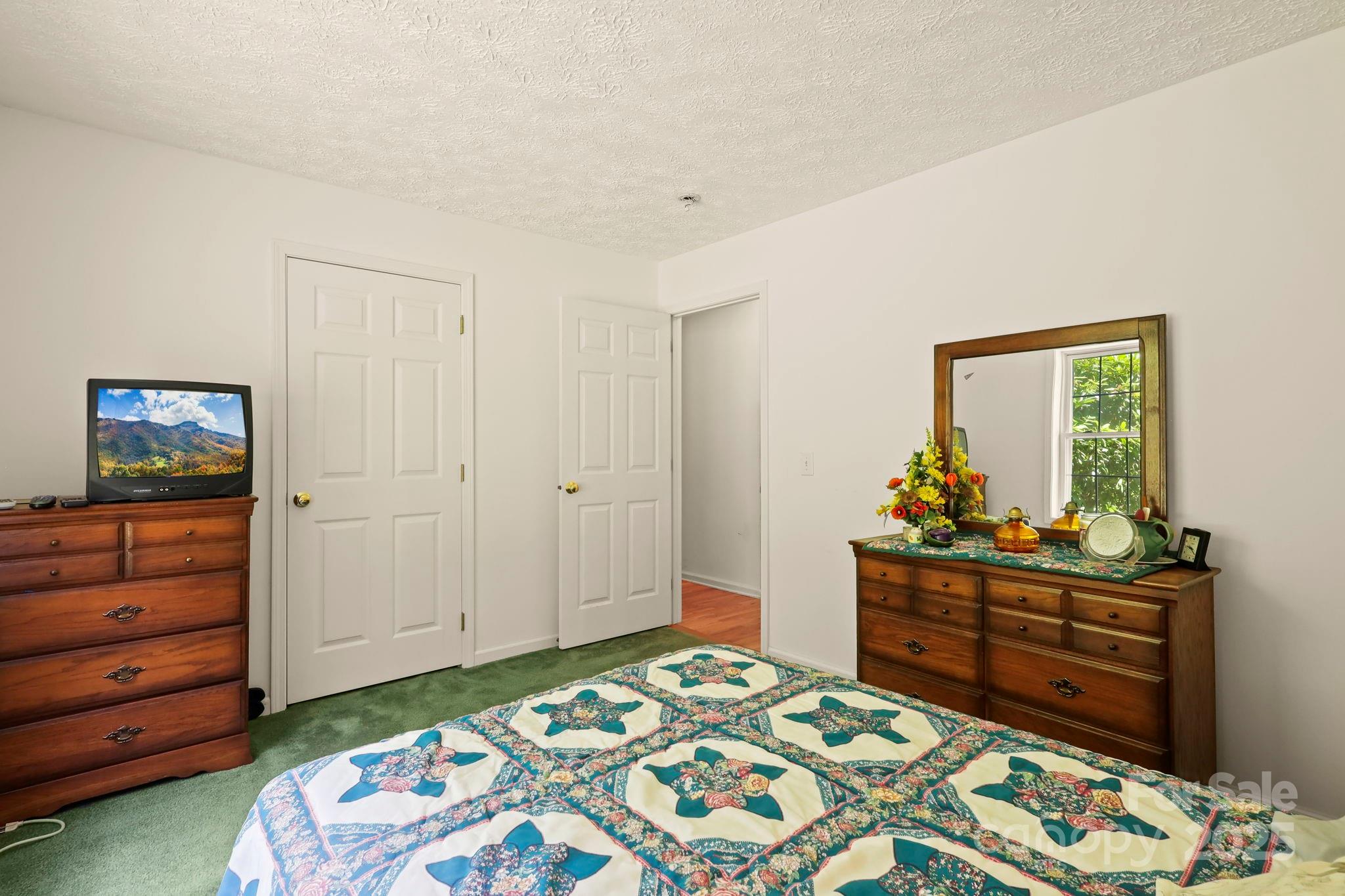 31 Barlow Road Elk Park, NC 28622 - Photo 21 of 40 a bedroom with a bed and furniture