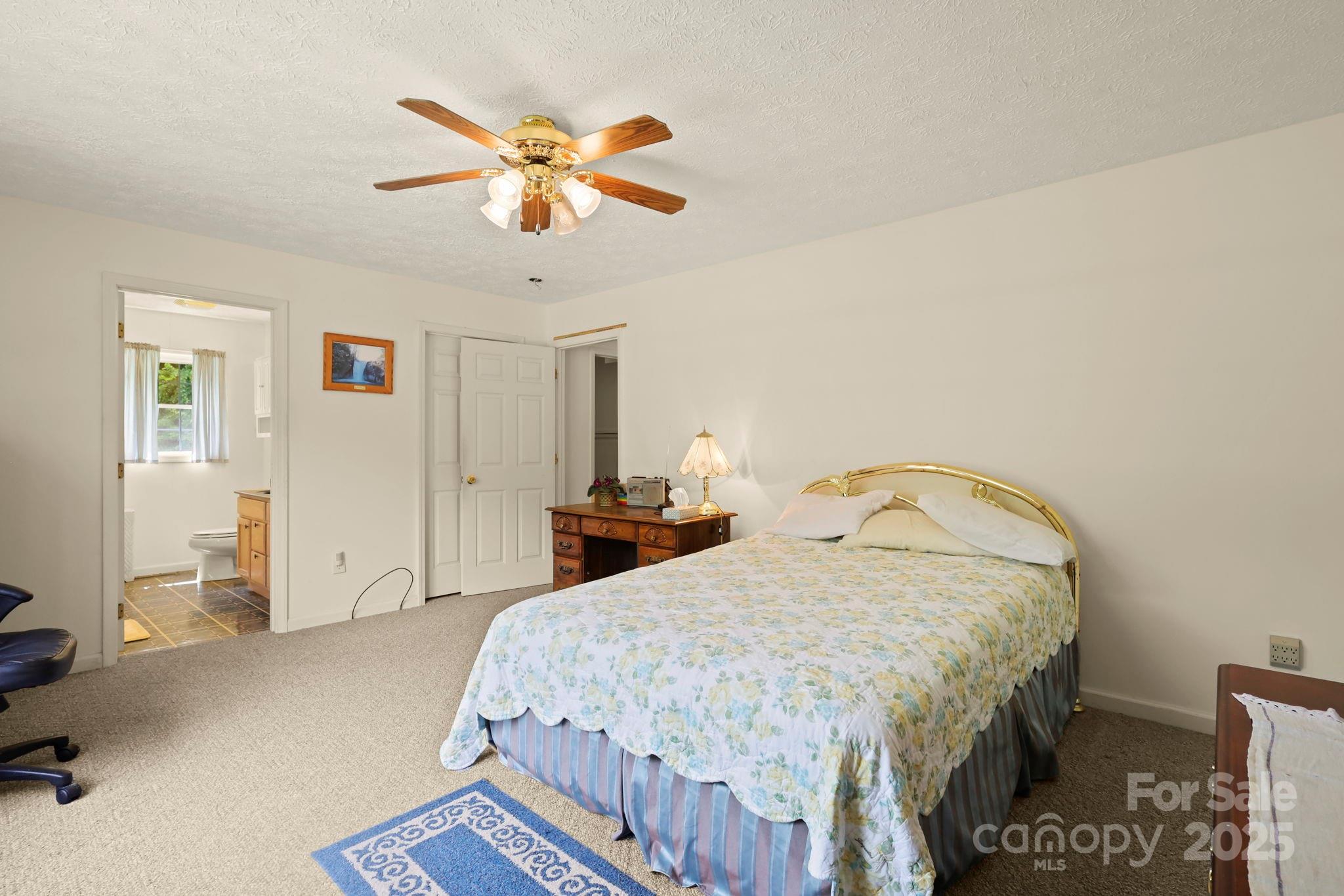 31 Barlow Road Elk Park, NC 28622 - Photo 24 of 40 a bedroom with a bed and a chandelier