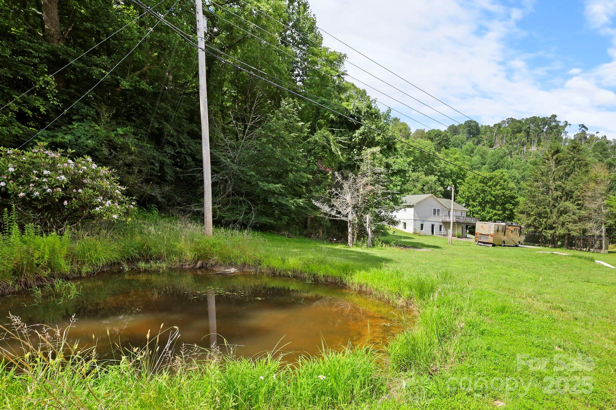 31 Barlow Road Elk Park, NC 28622 - Photo 38 of 40 a view of a lake with a house in the background