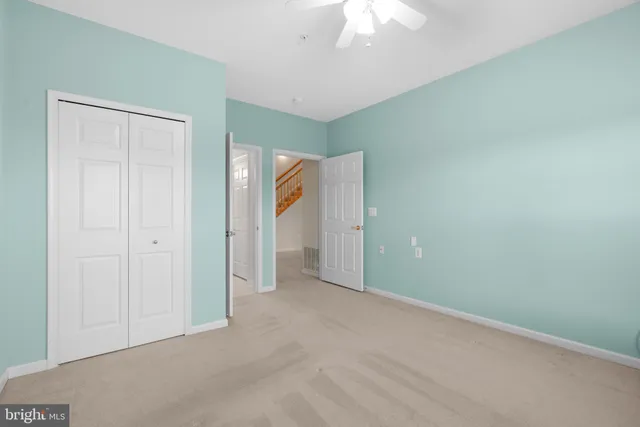 an empty room with a ceiling fan