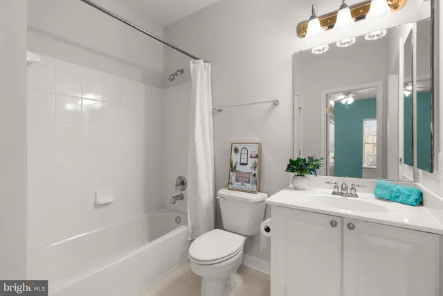 a bathroom with a sink toilet tub and shower