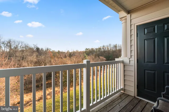 a view of a balcony with wooden fence and floor