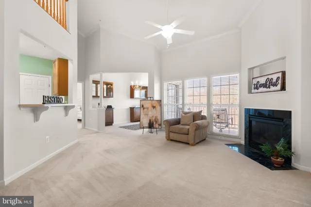 a living room with furniture a fireplace and a chandelier