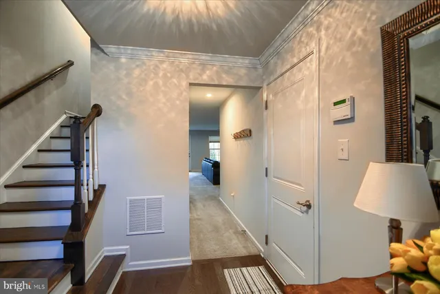 a view of a hallway with wooden floor and workspace