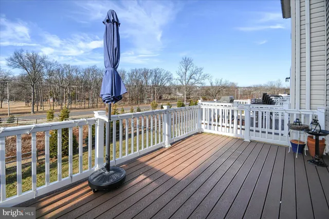 a view of balcony with wooden floor and fence