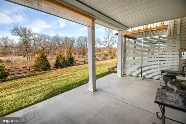 a view of a porch with furniture and garden