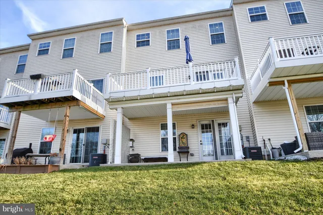 a view of a white building with large windows