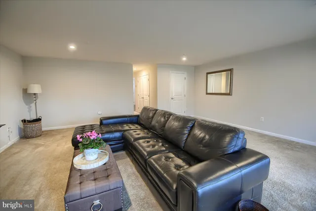 a living room with furniture and flowers