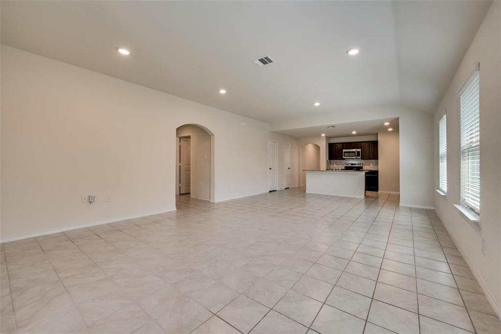 809 Costlow Lane Fate, TX 75189 - Photo 12 of 29 a view of empty room with furniture and a kitchen
