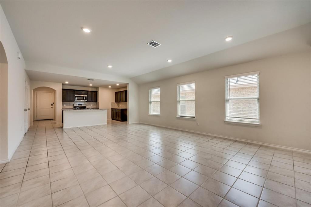 809 Costlow Lane Fate, TX 75189 - Photo 13 of 29 a view of empty room with kitchen and window