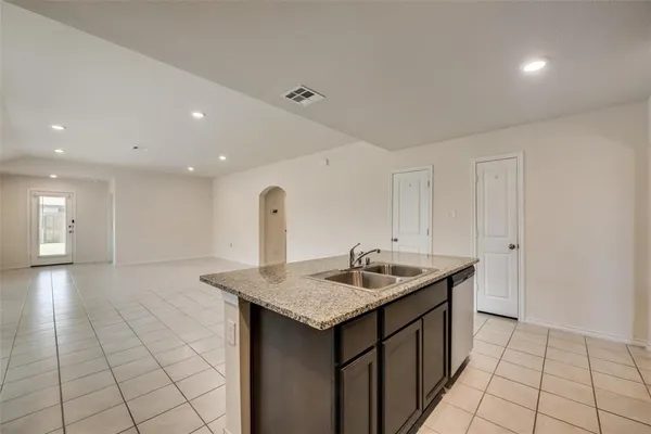 a kitchen that has a sink and a stove in it
