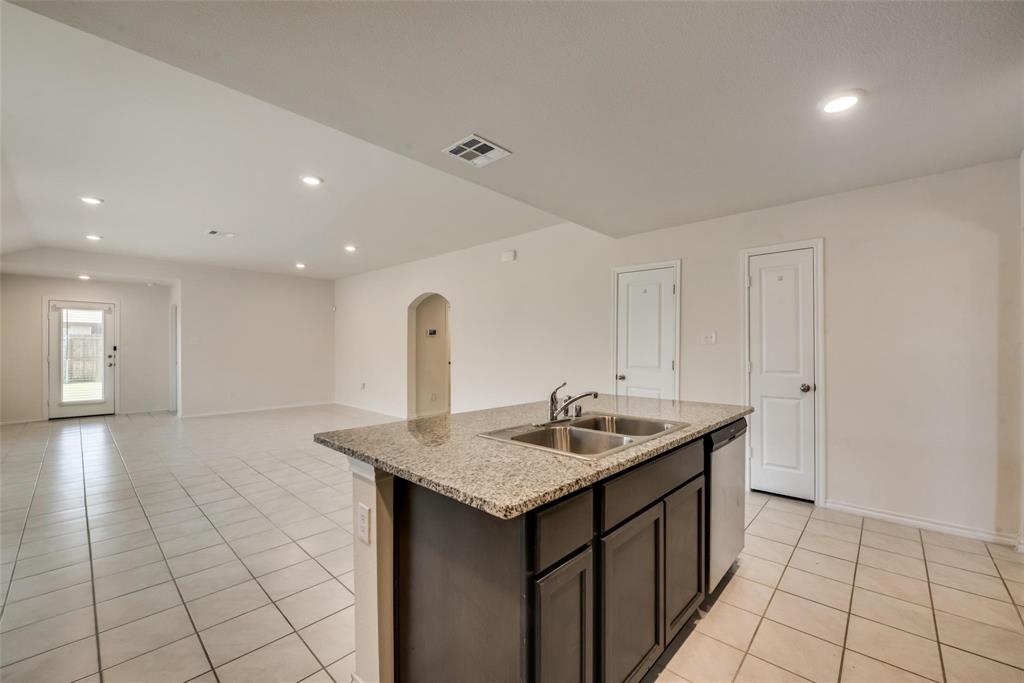 809 Costlow Lane Fate, TX 75189 - Photo 17 of 29 a kitchen that has a sink and a stove in it
