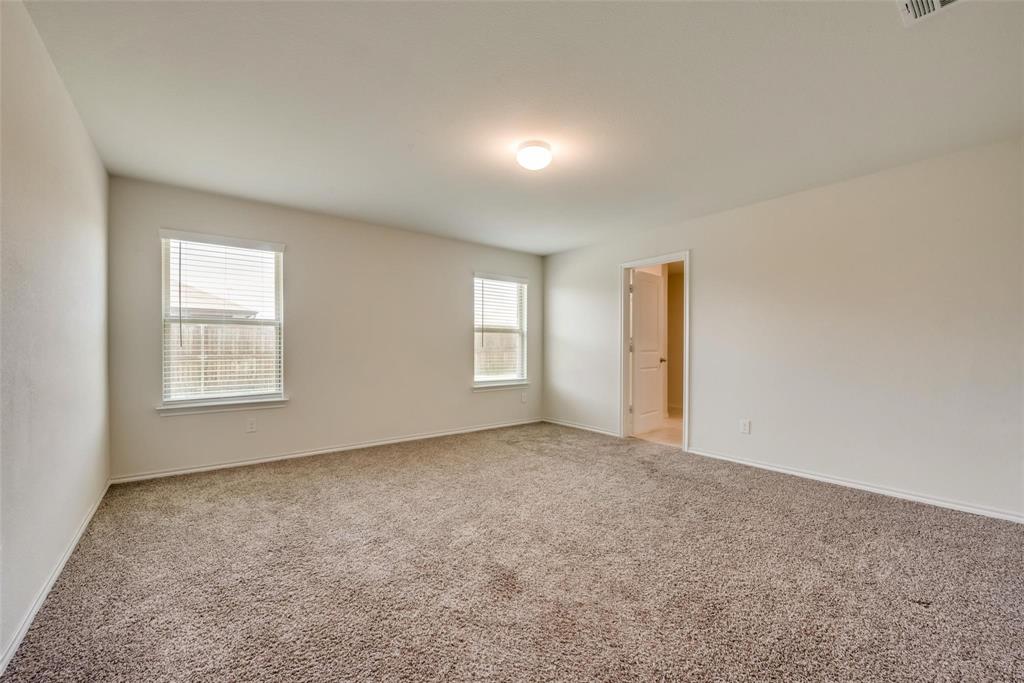 809 Costlow Lane Fate, TX 75189 - Photo 19 of 29 an empty room with windows