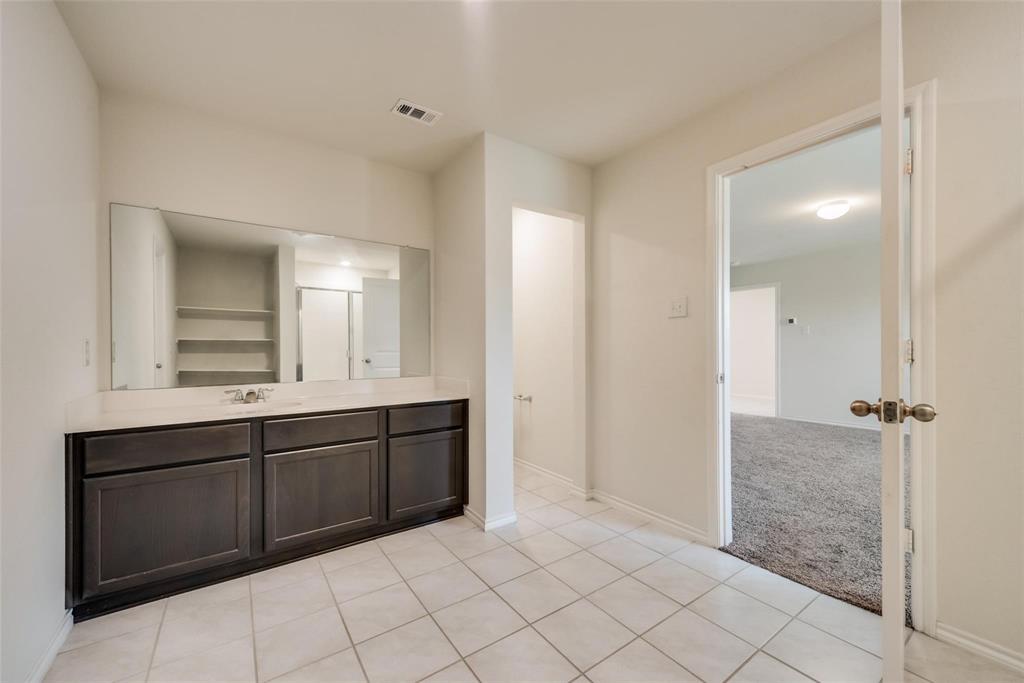 809 Costlow Lane Fate, TX 75189 - Photo 21 of 29 a spacious bathroom with a shower a sink and a mirror