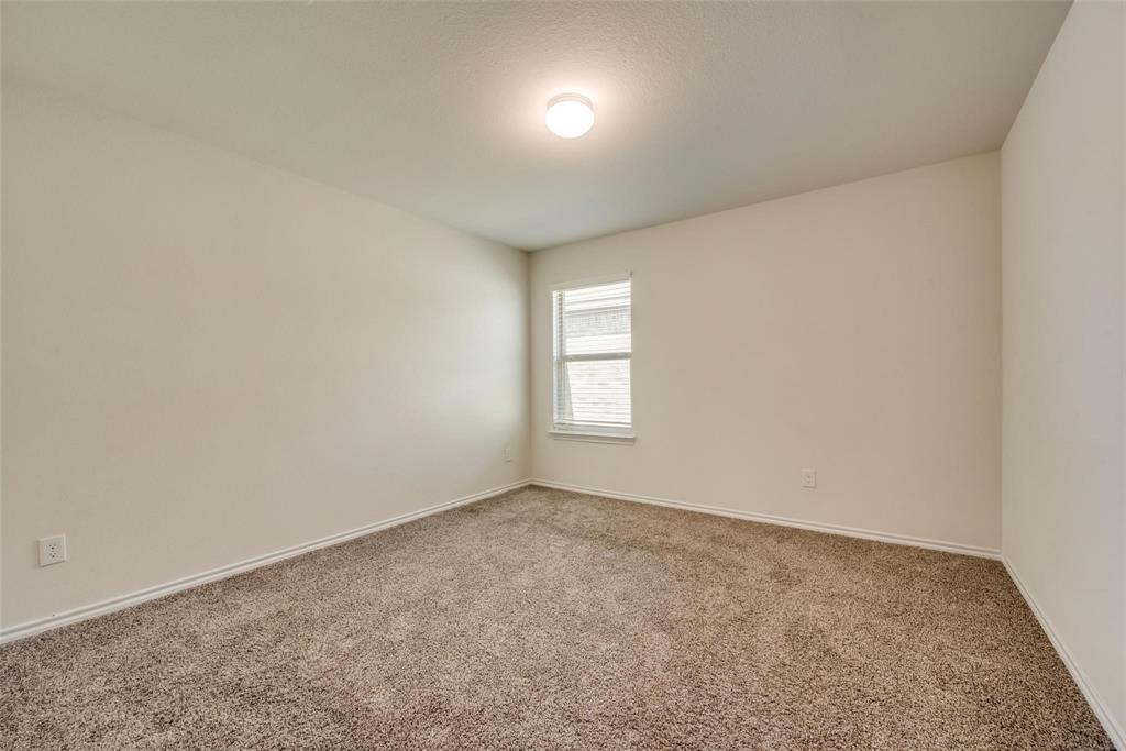 809 Costlow Lane Fate, TX 75189 - Photo 24 of 29 an empty room with a fan & windows