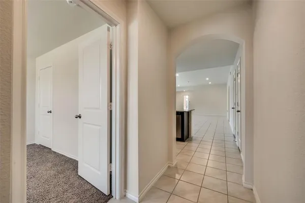 a view of a hallway with wooden shelves