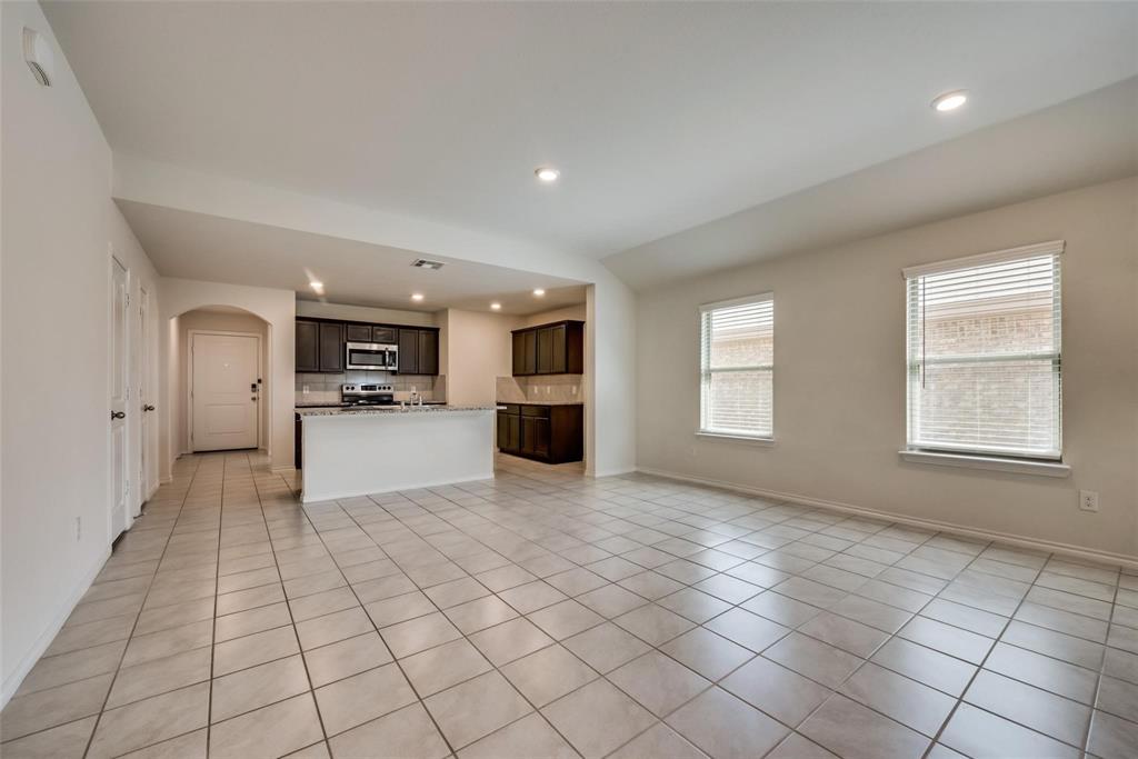 809 Costlow Lane Fate, TX 75189 - Photo 10 of 29 a view of empty room with kitchen and window