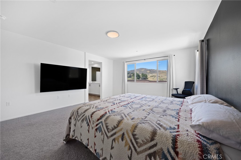 27059 Indigo Bush Road Menifee, CA 92586 - Photo 14 of 39 Primary Suite With Large Window And Wall-Mounted TV Setup