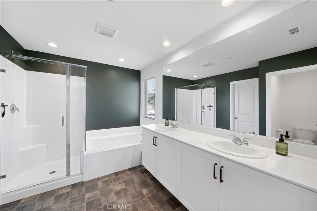 27059 Indigo Bush Road Menifee, CA 92586 - Photo 16 of 39 Primary Bathroom With Dual Vanities, Soaking Tub, And Separate Shower