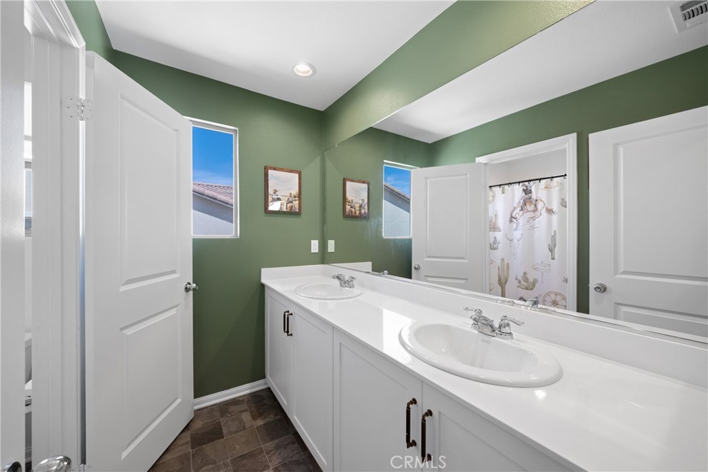 27059 Indigo Bush Road Menifee, CA 92586 - Photo 28 of 39 Bathroom With Dual Sinks And Extended Vanity Space