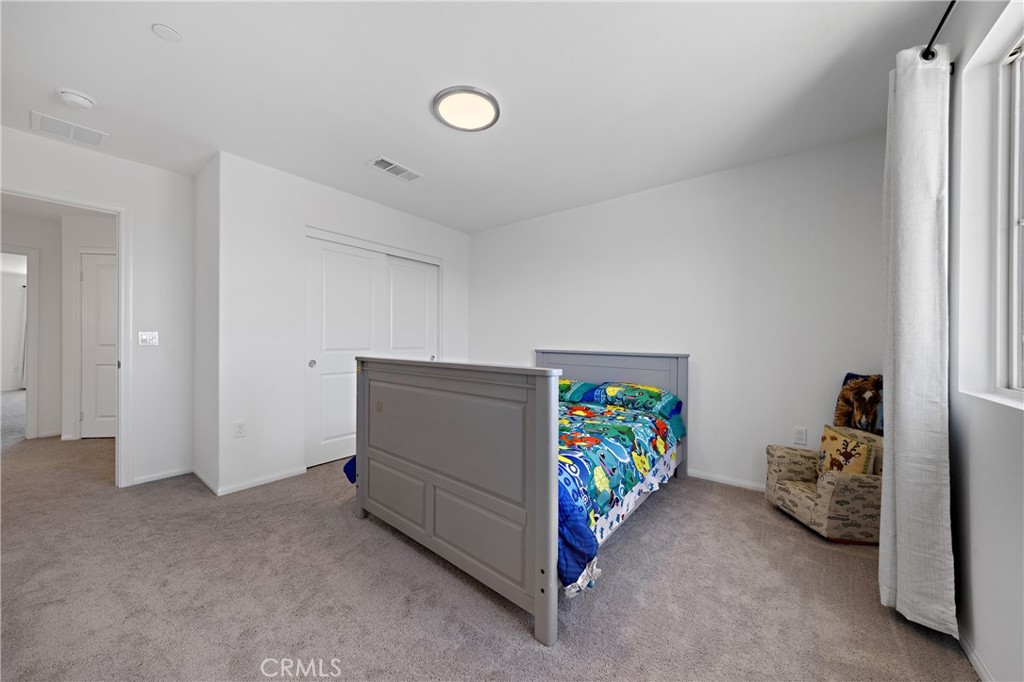 27059 Indigo Bush Road Menifee, CA 92586 - Photo 30 of 39 Bright Bedroom With Ample Space And Closet Access
