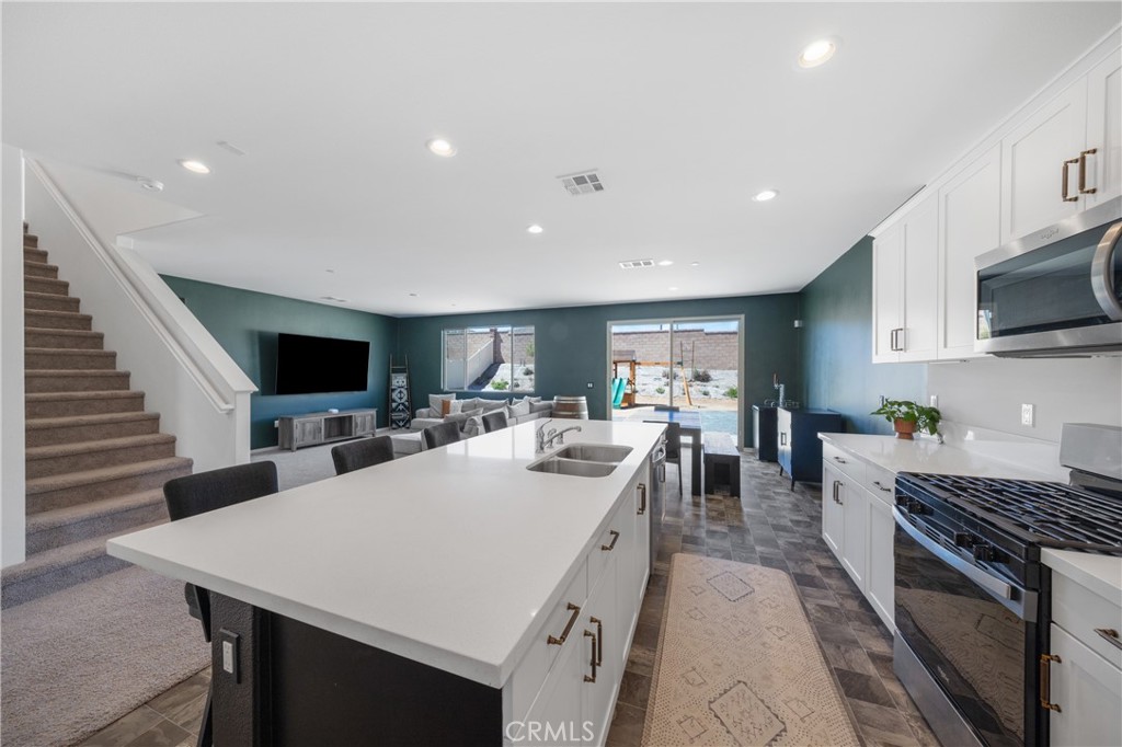 27059 Indigo Bush Road Menifee, CA 92586 - Photo 7 of 39 Expansive Kitchen And Living Area With Open Layout And Staircase View