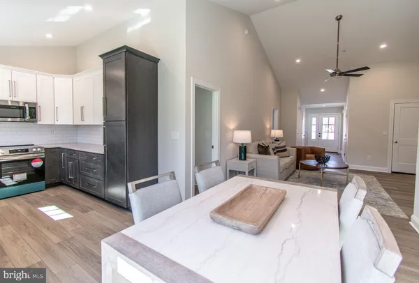 a large bedroom with sink mirror and bed