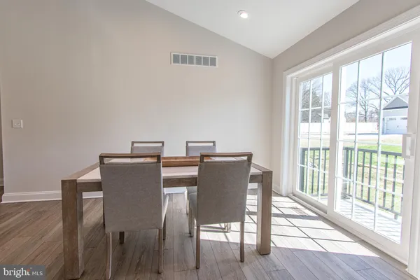 a view of a dining room with furniture wooden floor and next to a window