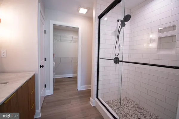 a bathroom with a granite countertop shower