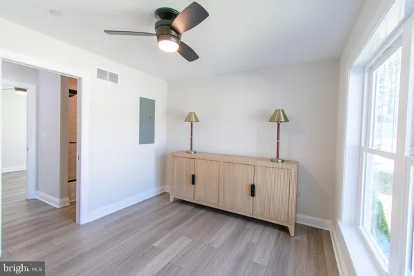 a hallway with closet and wooden floor