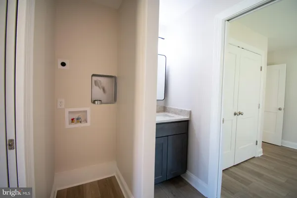 a view of bathroom with a sink mirror and shower