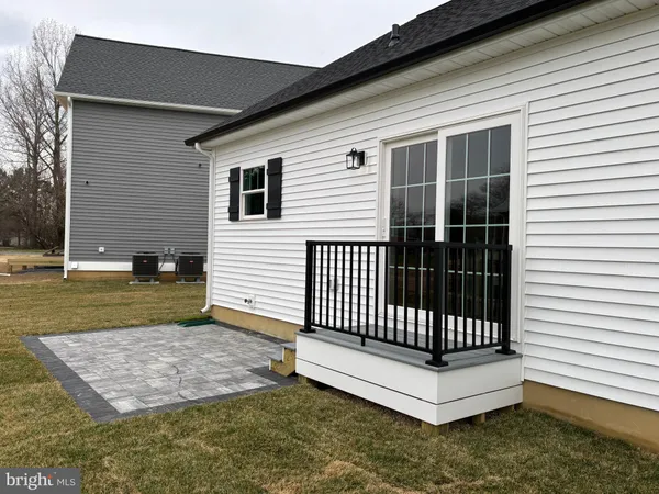 a view of a house with a small yard and wooden fence