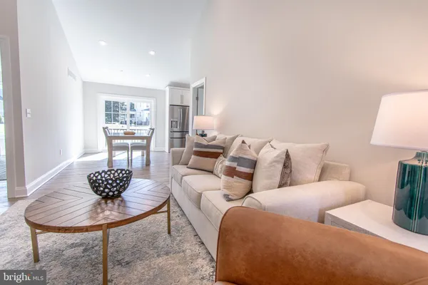 a living room with furniture a lamp and a table