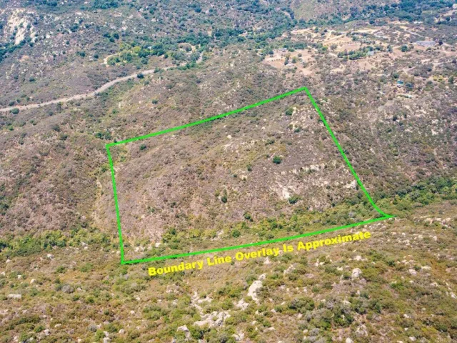 a view of a yard with wooden fence