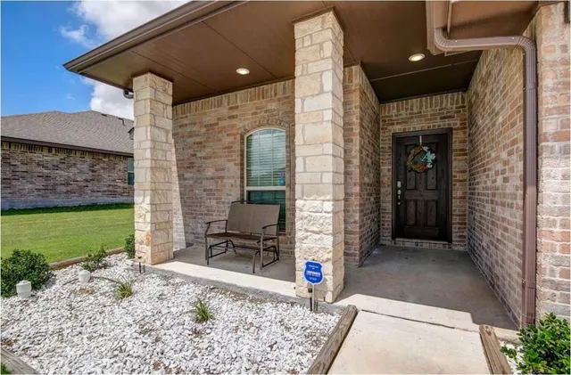 a front view of a house with outdoor seating