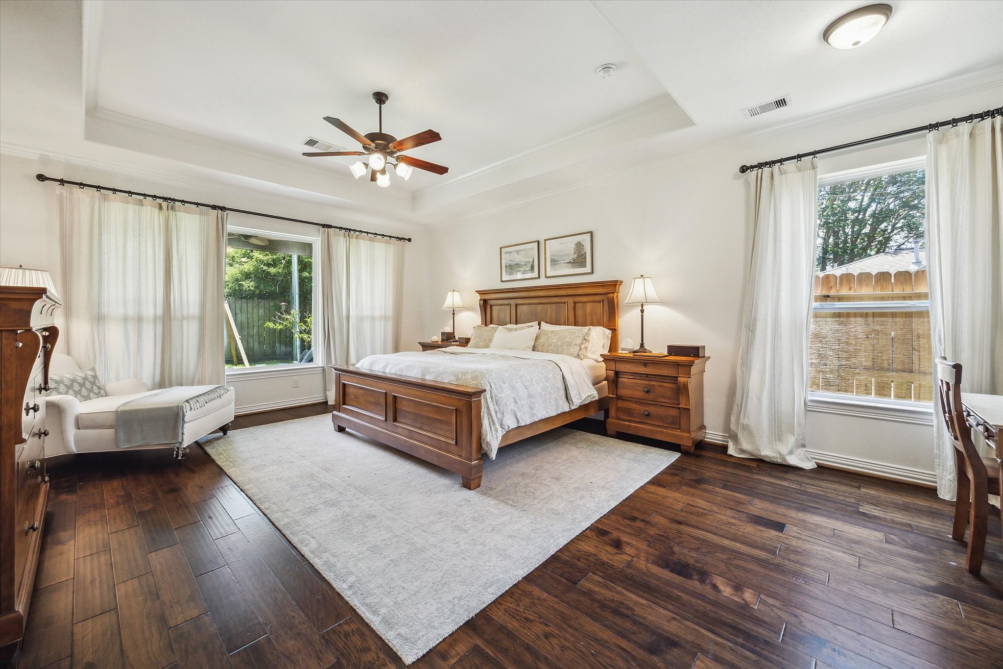 1515 Thornton Road Houston, TX 77018 - Photo 19 of 39 Overlooking the backyard, the beautifully appointed primary bedroom suite features a high tray ceiling, a luxurious en-suite bathroom and generous walk-in closets.