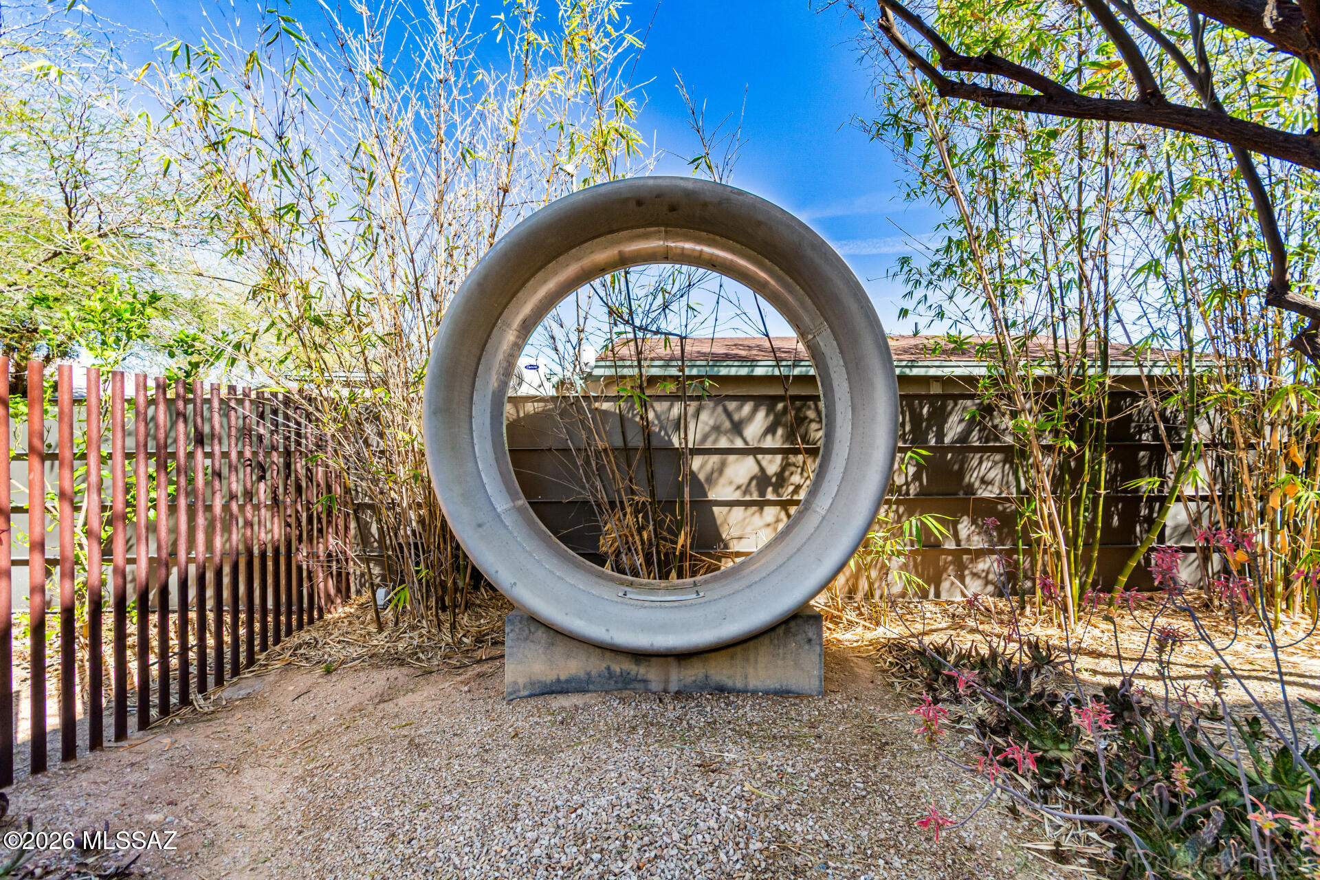 3605 East 3rd Street Tucson, AZ 85716 - Photo 37 of 39 This primary path terminates with an eight foot diameter jet engine cowling acquired from a local aircraft salvage yard. Perfectly round and unabashed, the cowling sculpture contrasts readily with the ninety degree angles of the architecture to create a modern day termination of axis.