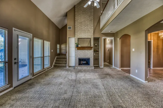 a view of a livingroom with an empty space and a fireplace