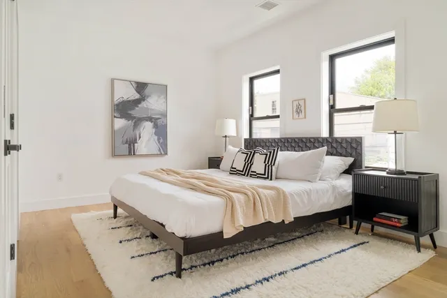 a bedroom with bed and a window