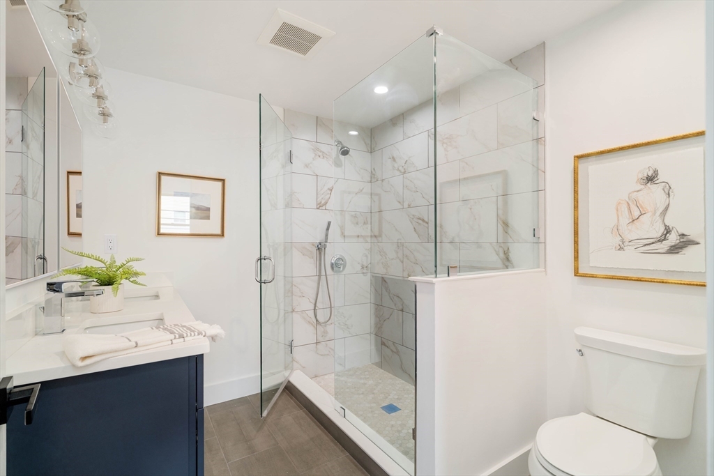 95 Addison Street, Unit A Boston, MA 02128 - Photo 3 of 12 a bathroom with a sink toilet and shower
