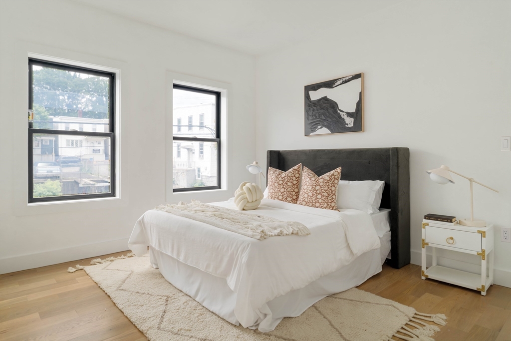 95 Addison Street, Unit A Boston, MA 02128 - Photo 5 of 12 a bedroom with a bed and a window