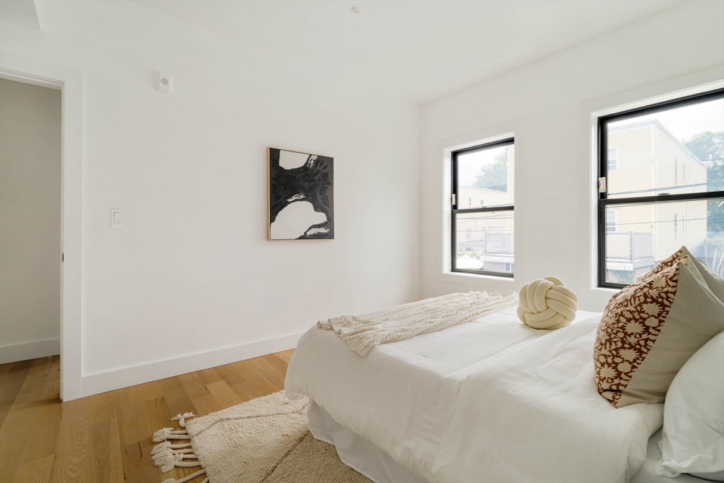 95 Addison Street, Unit A Boston, MA 02128 - Photo 7 of 12 a bedroom with a bed and a window