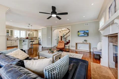a living room with furniture and kitchen view