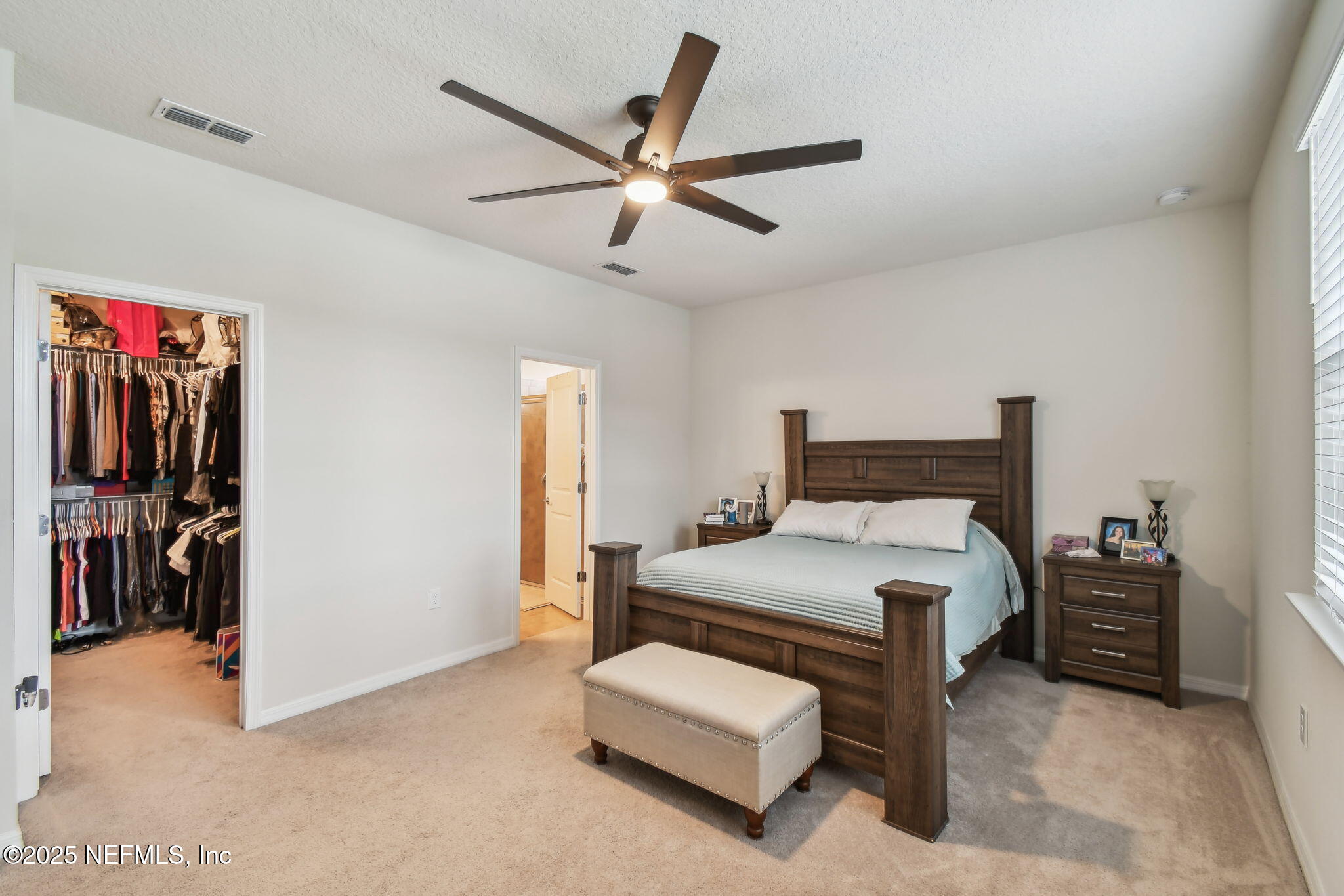 182 Myrtle Oak Court St. Augustine, FL 32092 - Photo 22 of 81 a bedroom with a bed and a chandelier