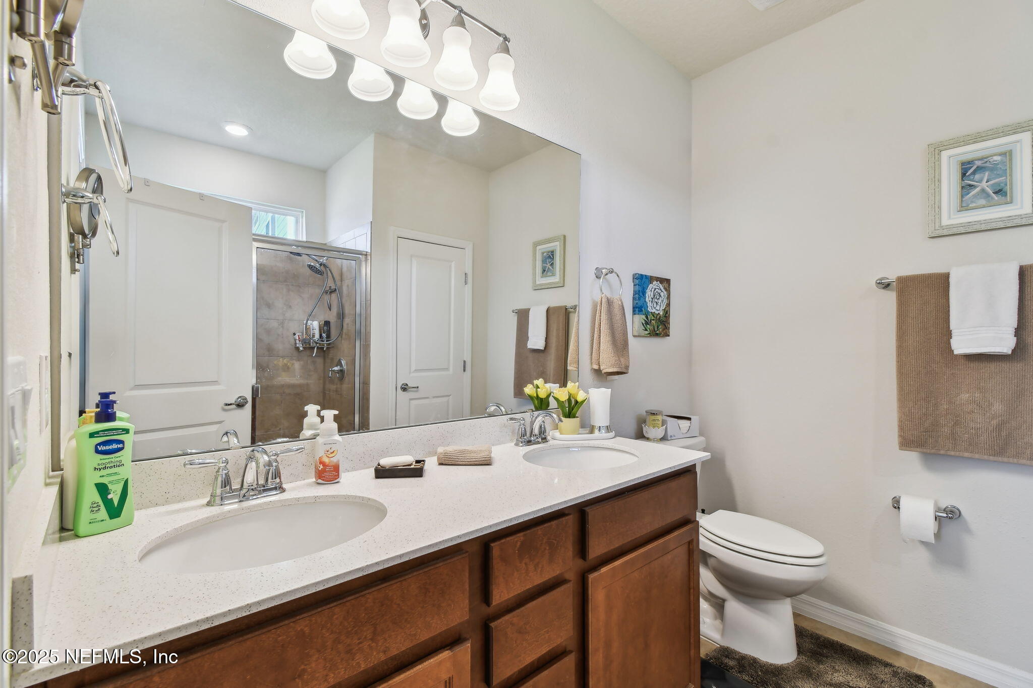 182 Myrtle Oak Court St. Augustine, FL 32092 - Photo 26 of 81 a bathroom with a sink a toilet and a mirror